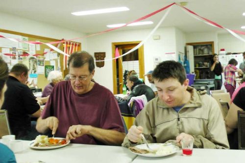 Brian and Zack enjoy a roast beef dinner at the 18th anniversary of the regular Wednesday Community Drop In at St. Andrew's Anglican church in Sharbot Lake that took place on October 15.   